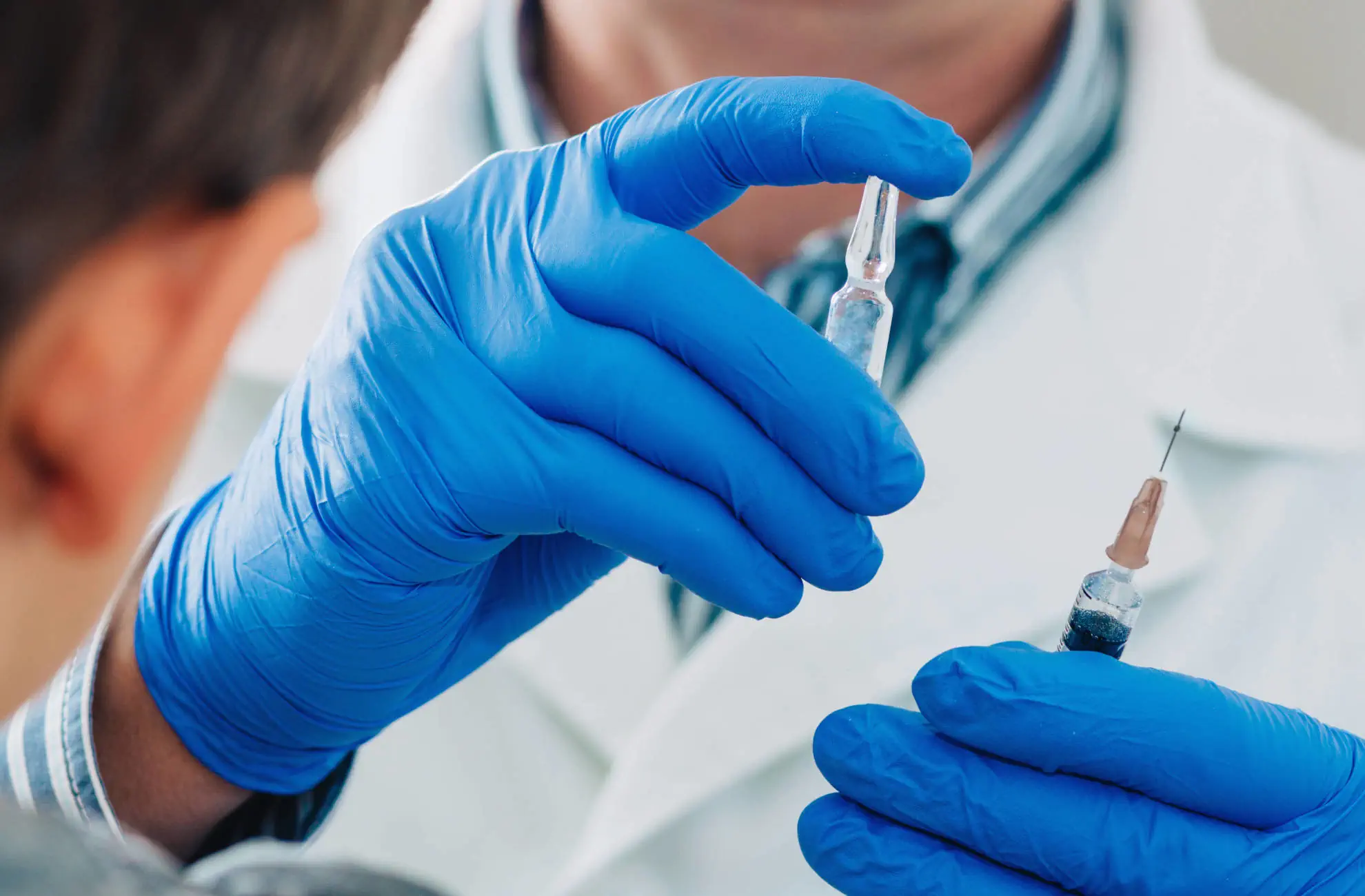 Medico con in mano fialette per vaccinazione